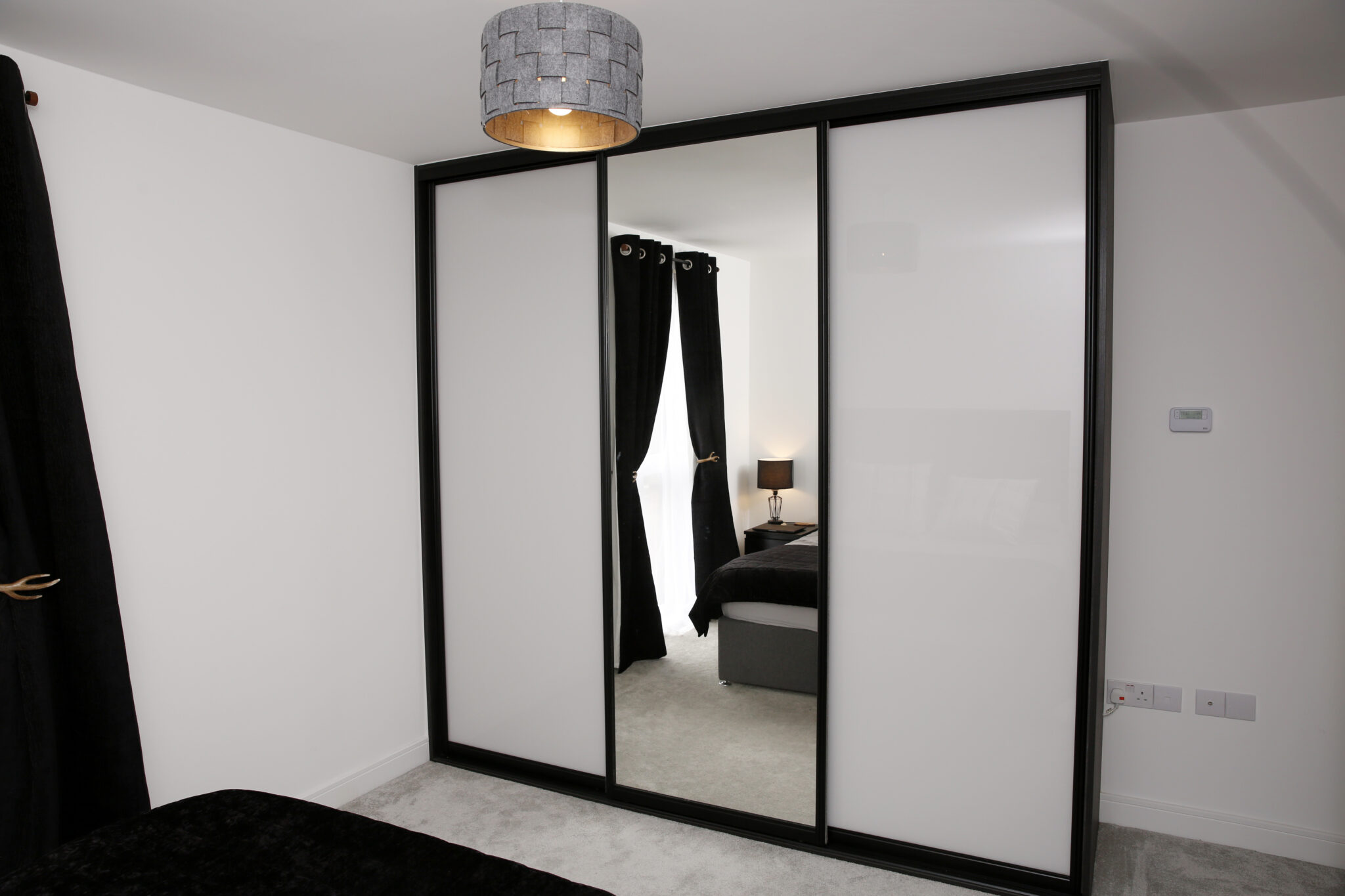 Chalk grey glass & mirror with black surround sliding door